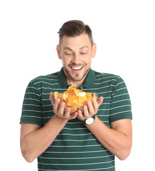 Man with bowl of potato chips on white background