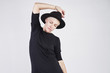 © olgapogorelova - Portrait of blond caucasian woman wearing black clothes and hat posing on white background.