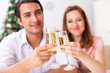 © Elnur - Young couple celebraring christmas with champagne