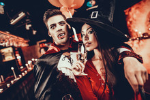 Young Happy Couple In Costumes At Halloween Party