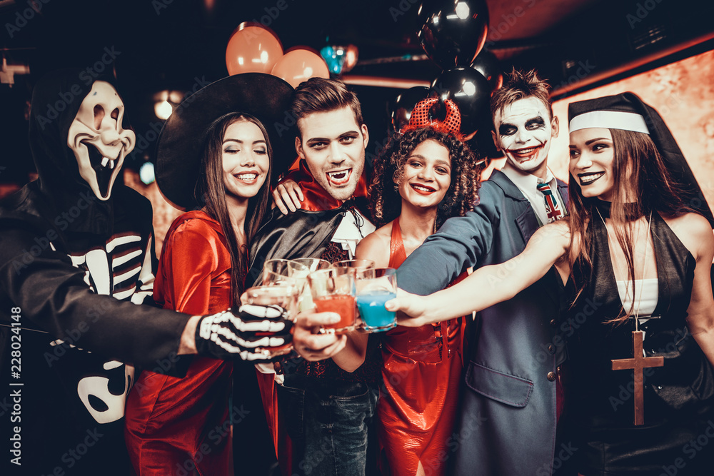 Friends in Halloween Costumes Drinking Cocktails - obrazy, fototapety, plakaty 