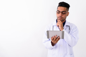 Young Indian man doctor wearing eyeglasses against white backgro