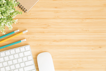 Wall Mural - flat lay photo of office desk with mouse and keyboard ,top view workpace on bamboo wood table and co