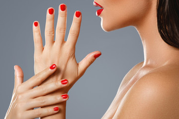 Canvas Print - Beauty and cosmetics. Female mouth and nails with red manicure and lipstick.