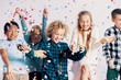 © Photographee.eu - Smiling multicultural group of kids having fun with confetti during friend's birthday