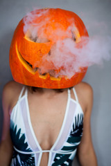 Poster - Sexy woman with carved pumpkin on her head for Halloween