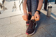 Woman tying shoelaces of sneakers