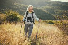Senior Woman Is Hiking In Mountain. Active Retirement.