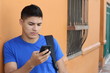 Young male browsing on his cellphone 