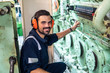 © Igor Kardasov - Marine engineer officer in engine control room ECR. Seamen's work. He starts or stops main engine of ship