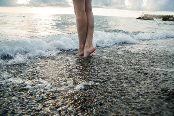 Feet in the water by the sea