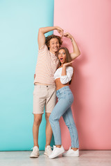 Wall Mural - Full length of smiling young couple standing