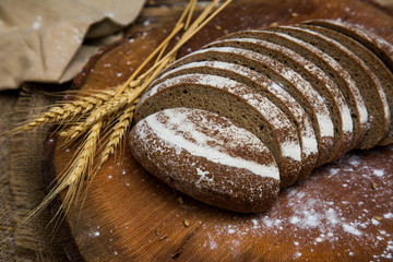 White wheat rye sliced tasty and delicious bread on wooden background