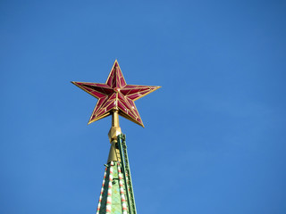 Wall Mural - Red star on Moscow Kremlin tower isolated on clear blue sky, soviet and russian symbol