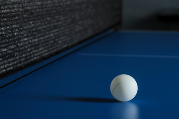 Wall Mural - Ping-pong ball on a blue table tennis table. Sport. Sport game