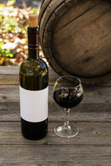 Wall Mural - Red wine bottle on a wooden background