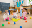 © Andrey Kuzmin - Group of children playing balls in kindergarten or daycare centre