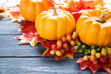 Wall Mural - autumn maple leaves and pumpkin on old wooden backgound. thanksgiving day concept.