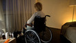 © motortion - Elderly lady in wheelchair looking though window feeling lonely and depressed