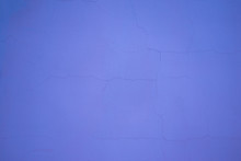 Purple Plaster Background On The Wall. Cracked Plaster Texture Background. Purple Plastered Wall With Small Cracks. Purple Background For The Designer: Cracked Wall Putty Texture.