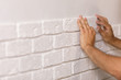 © producer - Professional Builder gluing decorative tile on wall.
