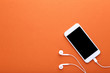 © 5second - Smartphone with earphones on orange background