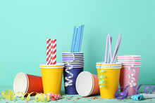 Colorful Paper Cups With Straws And Confetti On Mint Background