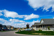  a new housing subdivision with a cloudy blue sky
