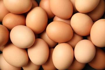 pile of raw brown chicken eggs, top view