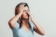 Sinus pain, sinus pressure, sinusitis. Sad woman holding her nose and head because sinus pain