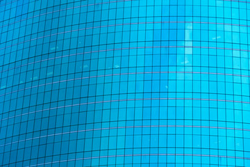 Poster - windows of blue modern office skyscraper building. architecture in smart technology concept. abstrac