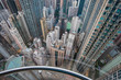 View from a glass elevator above the city and scyscrapers, vertigo inducing view looking down on a modern city