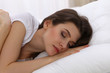 © rogerphoto - Beautiful young woman sleeping while lying in her bed. Concept of pleasant and rest reinstatement for active life