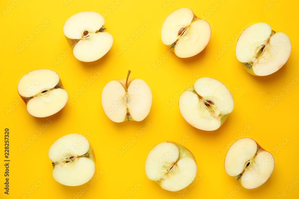 Cut fresh apples on color background