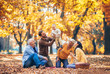 © Mediteraneo - Multl generation family in autumn park having fun