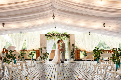 Wedding Ceremony Elegant Wedding Couple Kissing Near Wedding Arch
