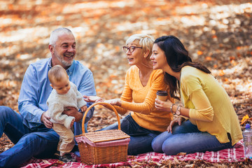 Wall Mural - Multl generation family in autumn park having fun