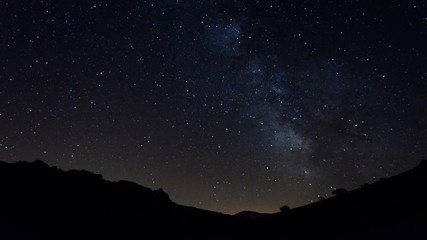Wall Mural - the milky way moving across the night sky, stars time lapse