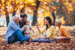 © Mediteraneo - Multl generation family in autumn park having fun