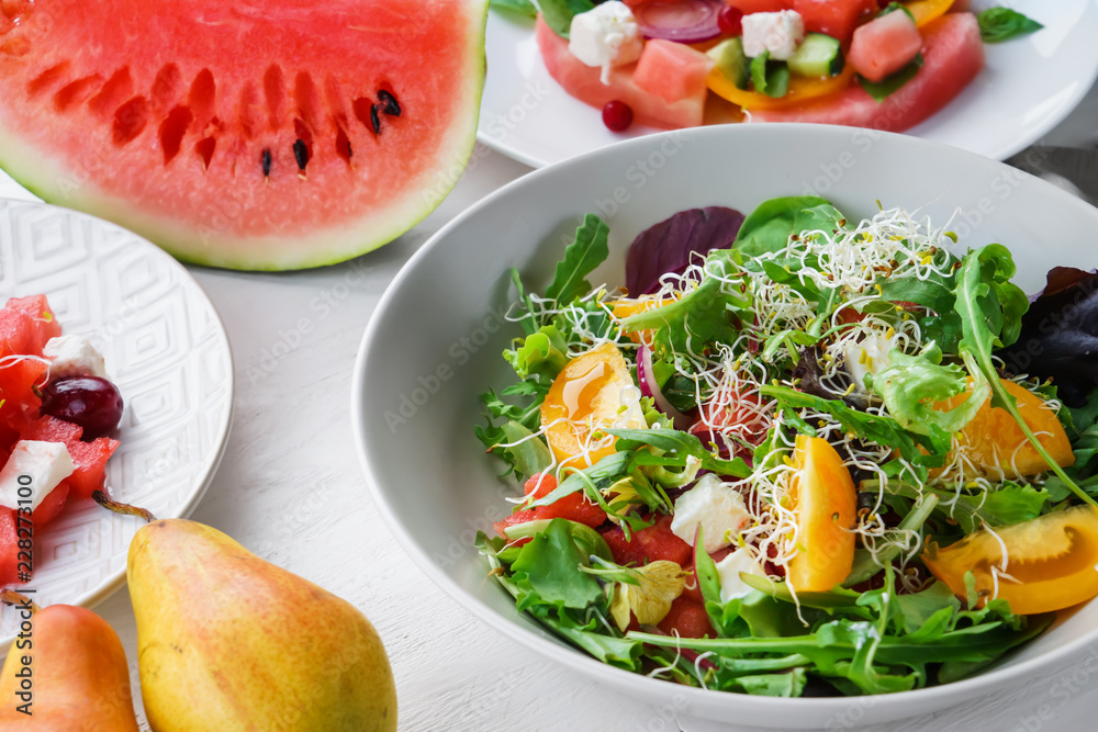 Plate with delicious watermelon salad on white table