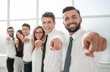 Wall Mural - business team standing in new office and pointing forward