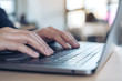 © Farknot Architect - Closeup image of hands using and typing on laptop keyboard on table