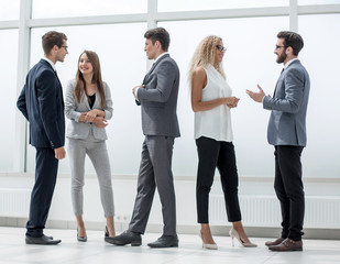 in full growth.a group of business people talking in the lobby o