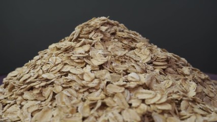 Poster - Hill of oatmeal on a dark background, rotation 360 degrees. 