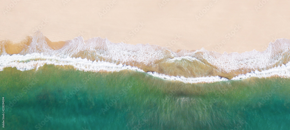 Waves on the beach as a background - obrazy, fototapety, plakaty 
