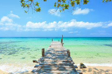 Wall Mural - Long wooden bridge go to the sea in beautiful tropical island, Thailand.