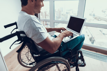 Disabled Man Holding Laptop and Typing on Lap