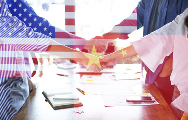 Wall Mural - Double exposure of the flag of china and United States of America with businessmen shaking hands. Business partnership meeting and greeting concept, success, dealing, greeting and partner concept.