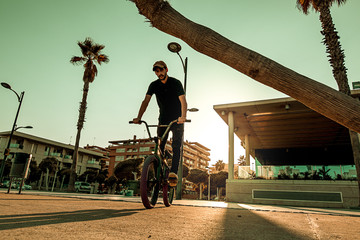 Wall Mural - Young man with a bmx bike around the city