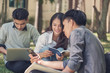 © palidachan - Group of university students sitting and talking together in campus, Happy Diverse students team concept.